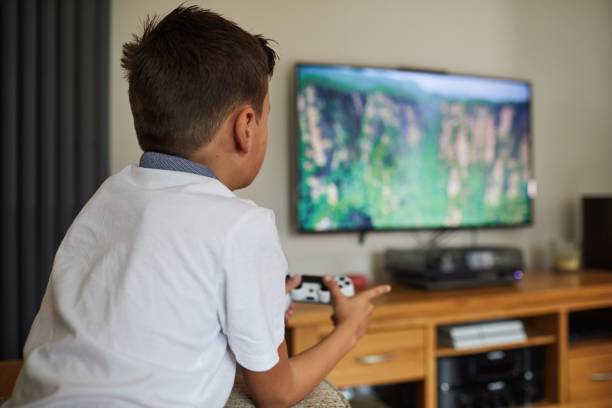 View from behind of child playing on video games